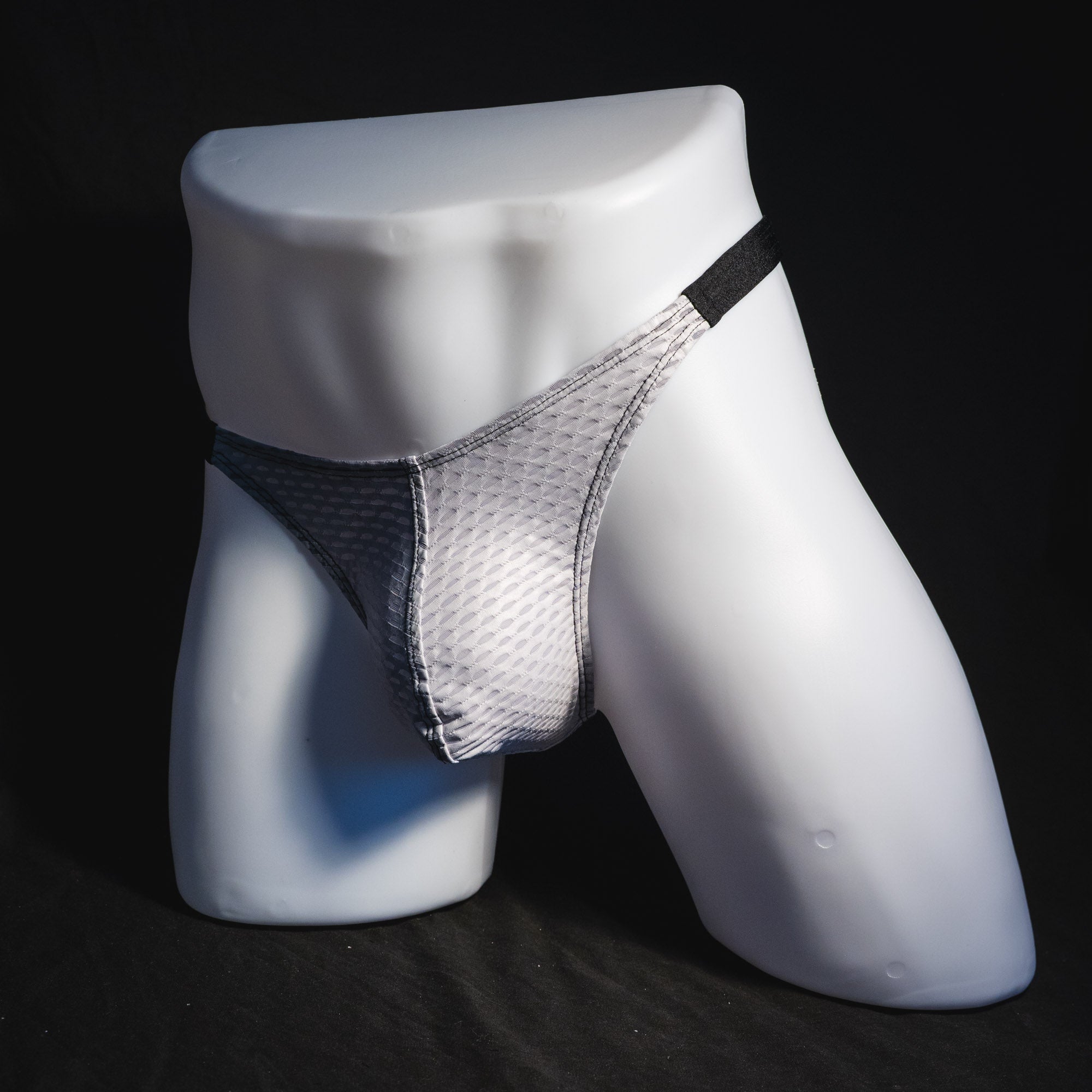 Men's ash white and black athletic mesh thong underwear, classic cut, full angled front view.