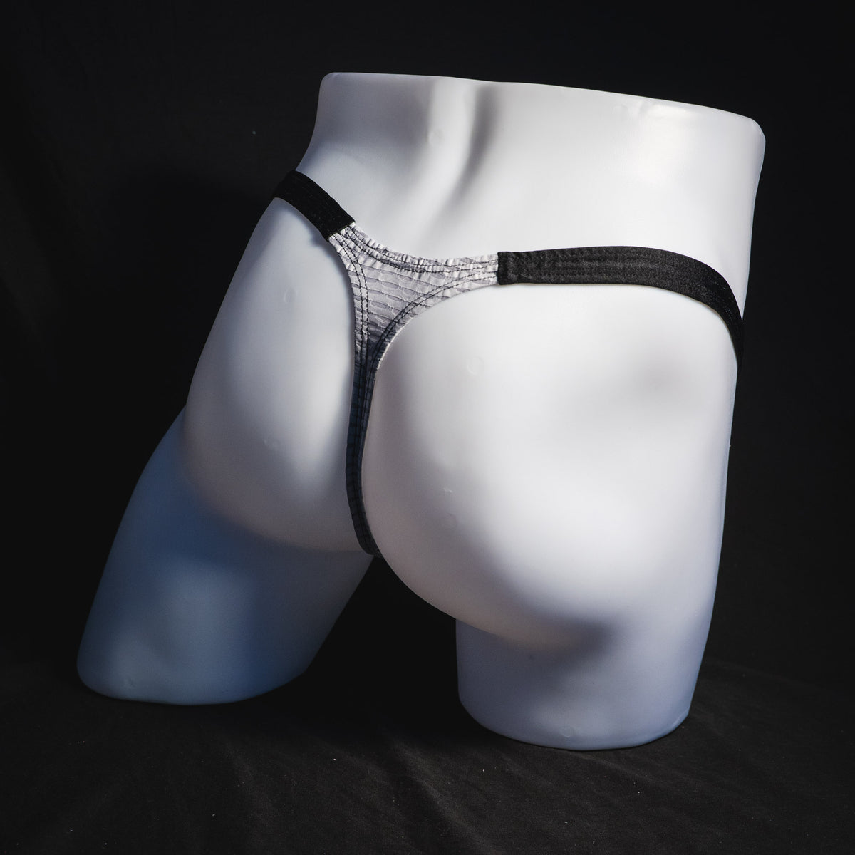 Men's ash white and black athletic mesh thong underwear, classic cut, full angled rear view.