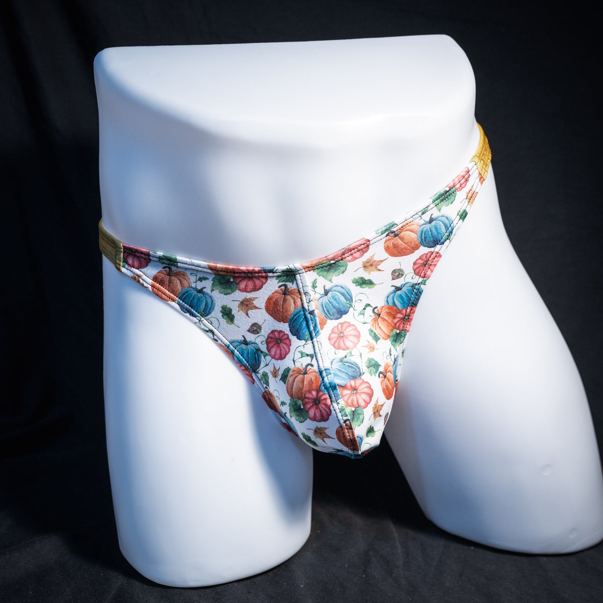 Men's colorful autumn pumpkins thong underwear, classic cut, front view.