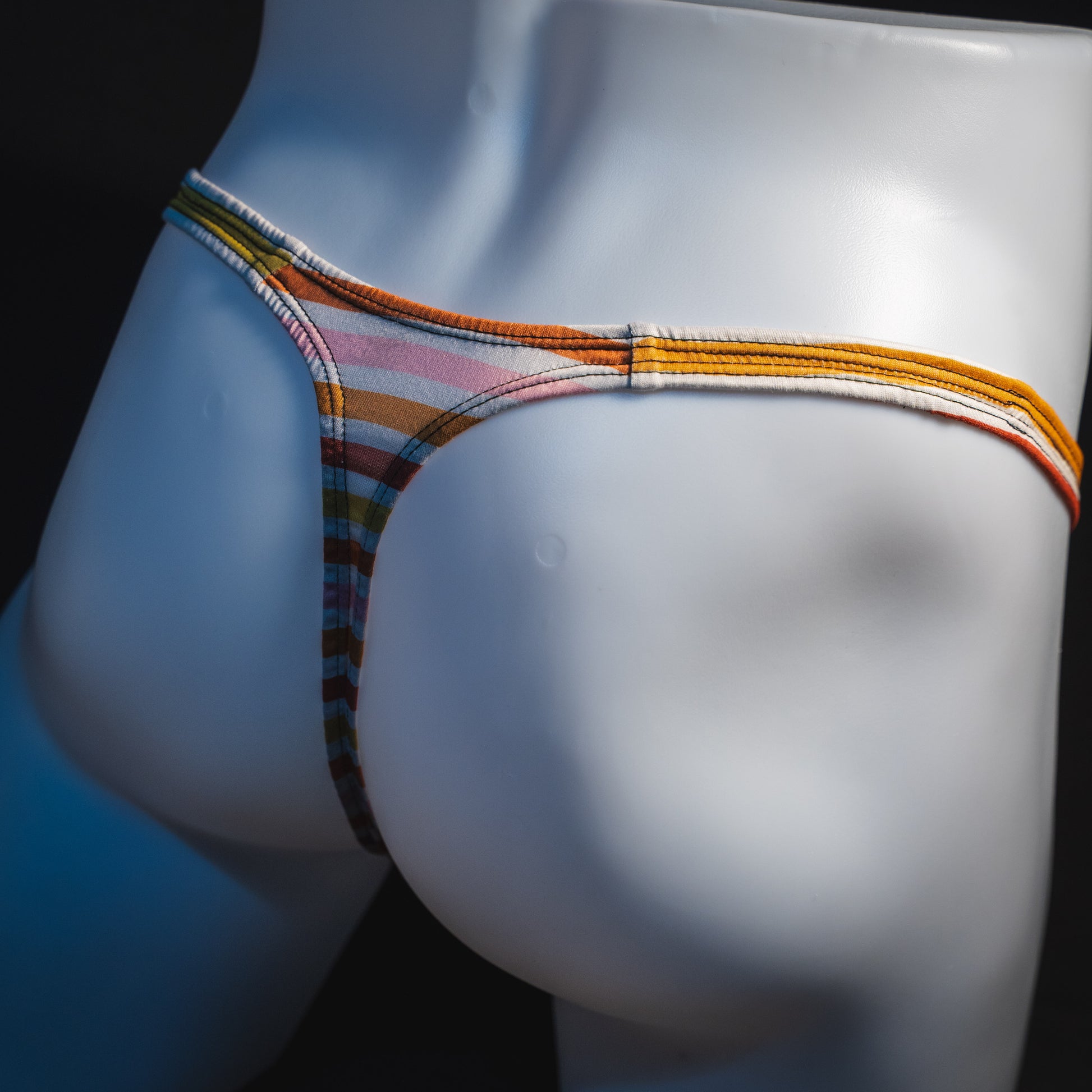 Men's Autumn striped thong underwear, classic cut, angled rear view.