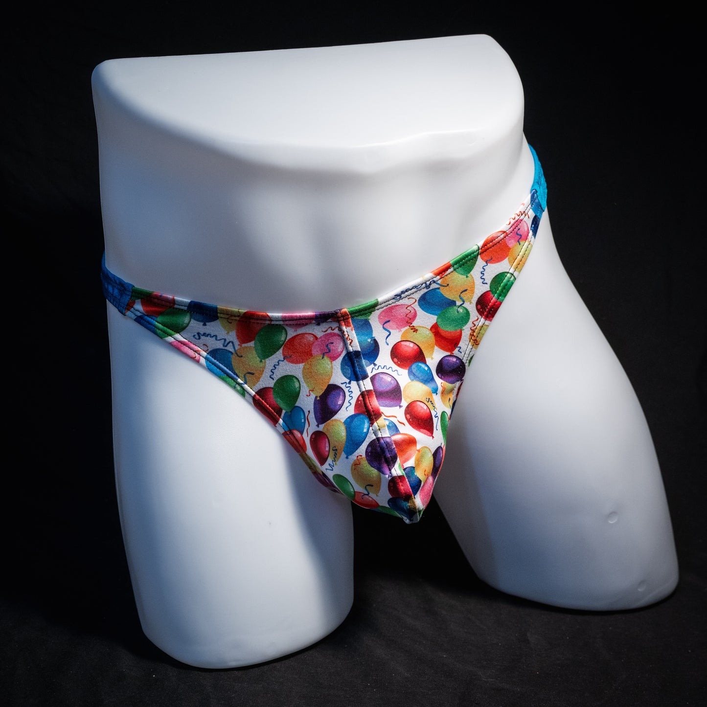 Men's colorful balloons thong underwear, classic cut, front view.