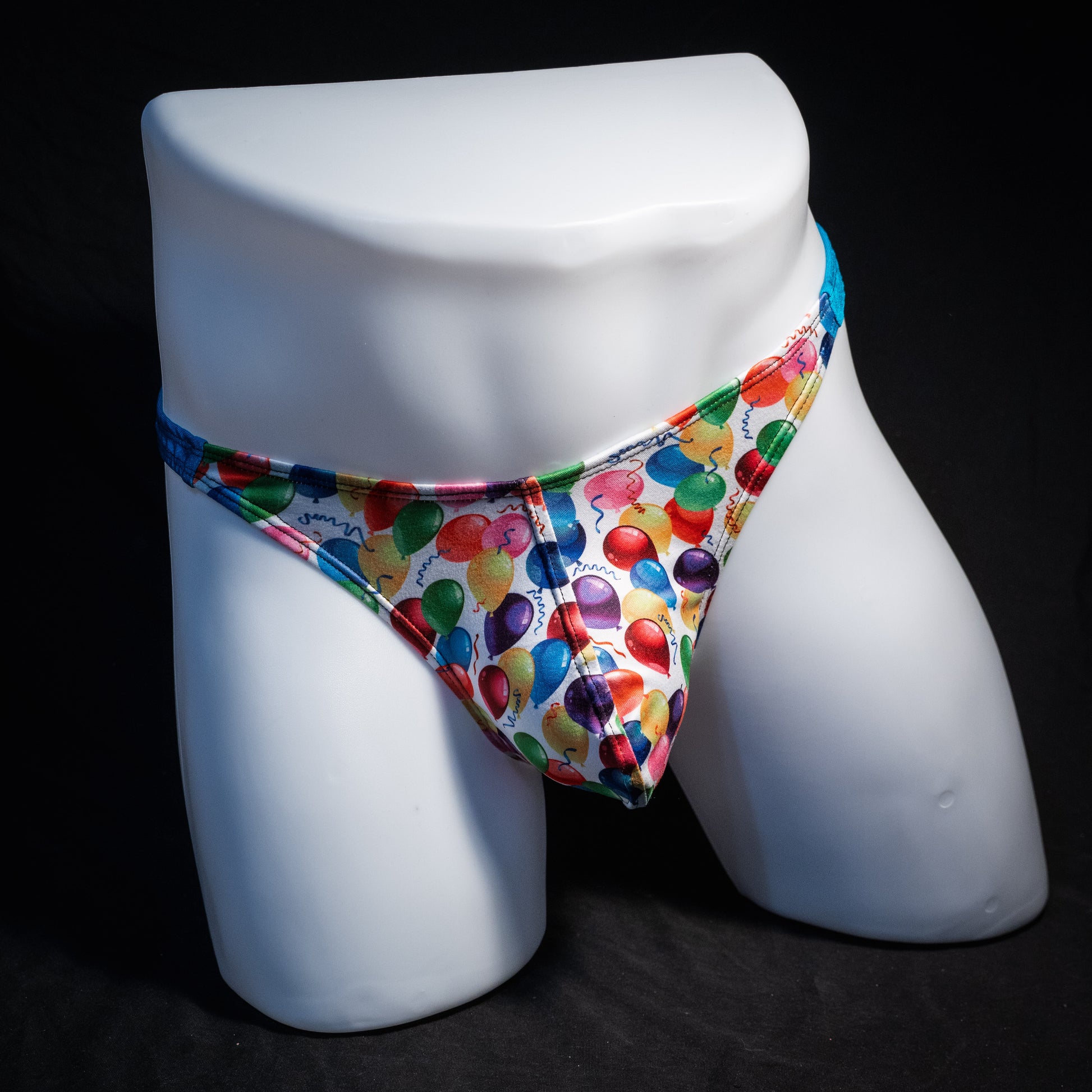 Men's colorful balloons thong underwear, classic cut, front view.
