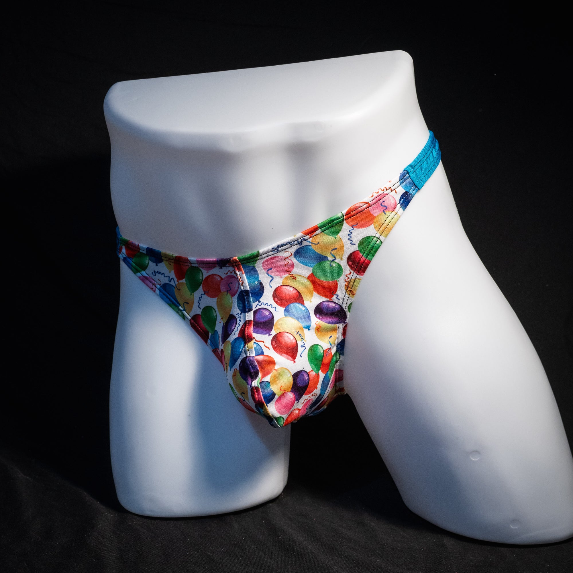 Men's colorful balloons thong underwear, classic cut, front view.