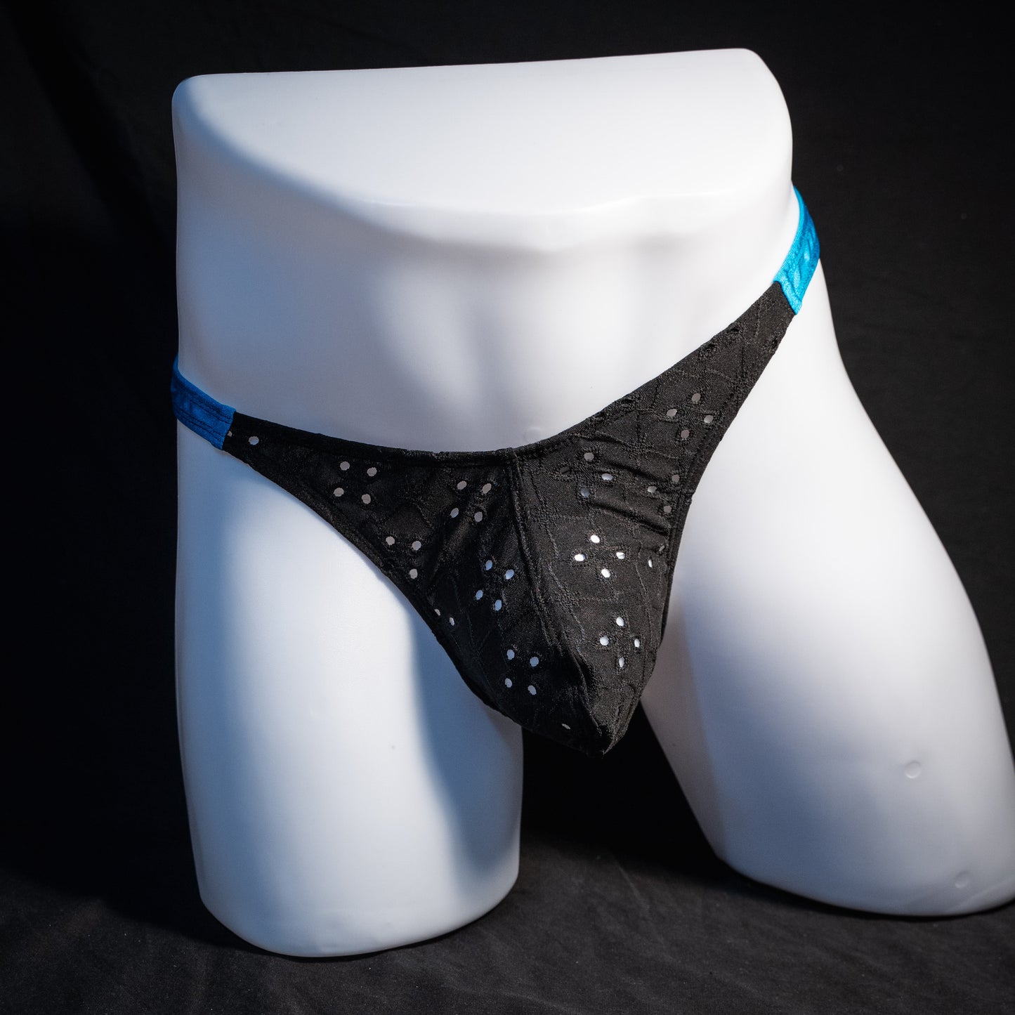 Men's black and blue eyelet thong underwear, classic cut, front view.