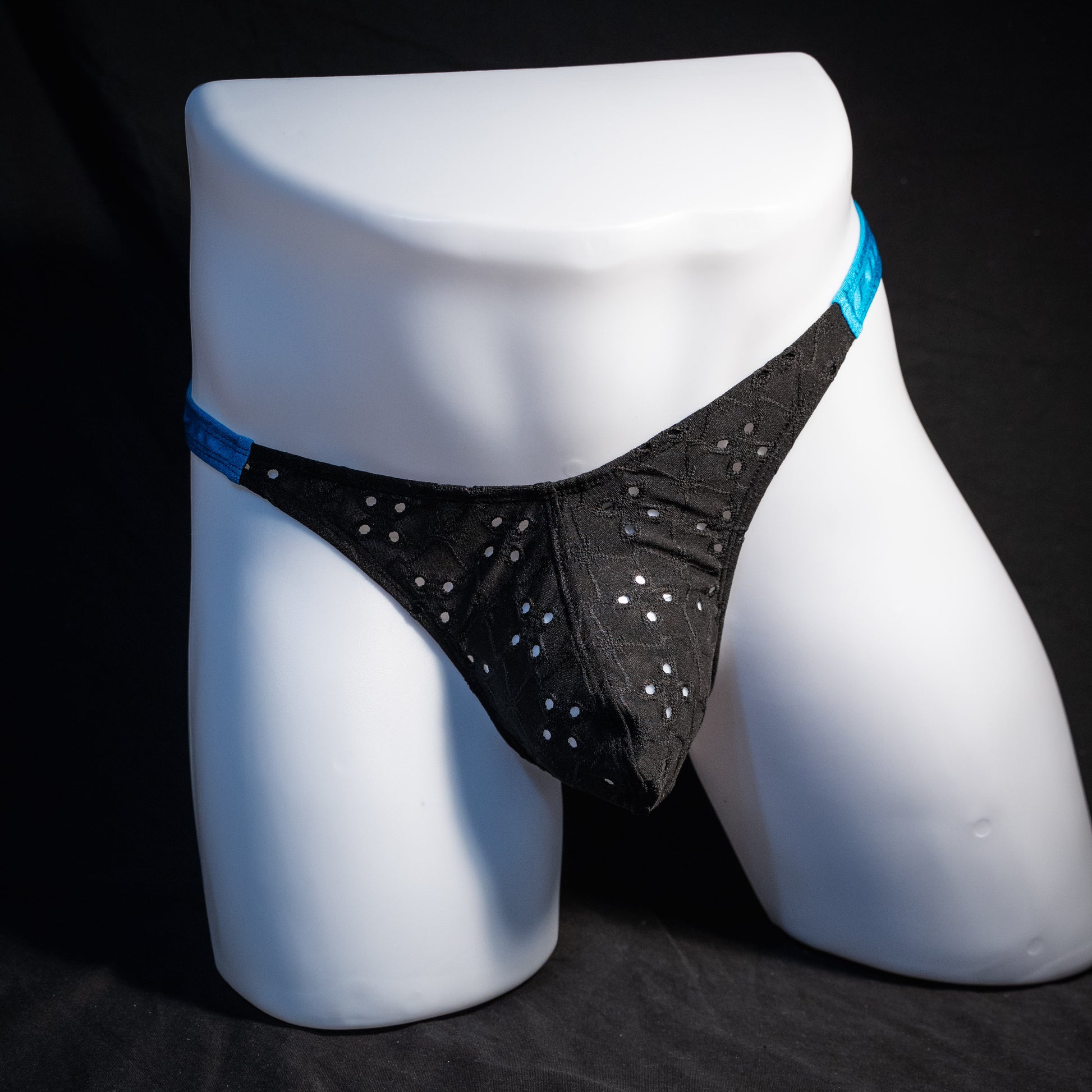 Men's black and blue eyelet thong underwear, classic cut, front view.
