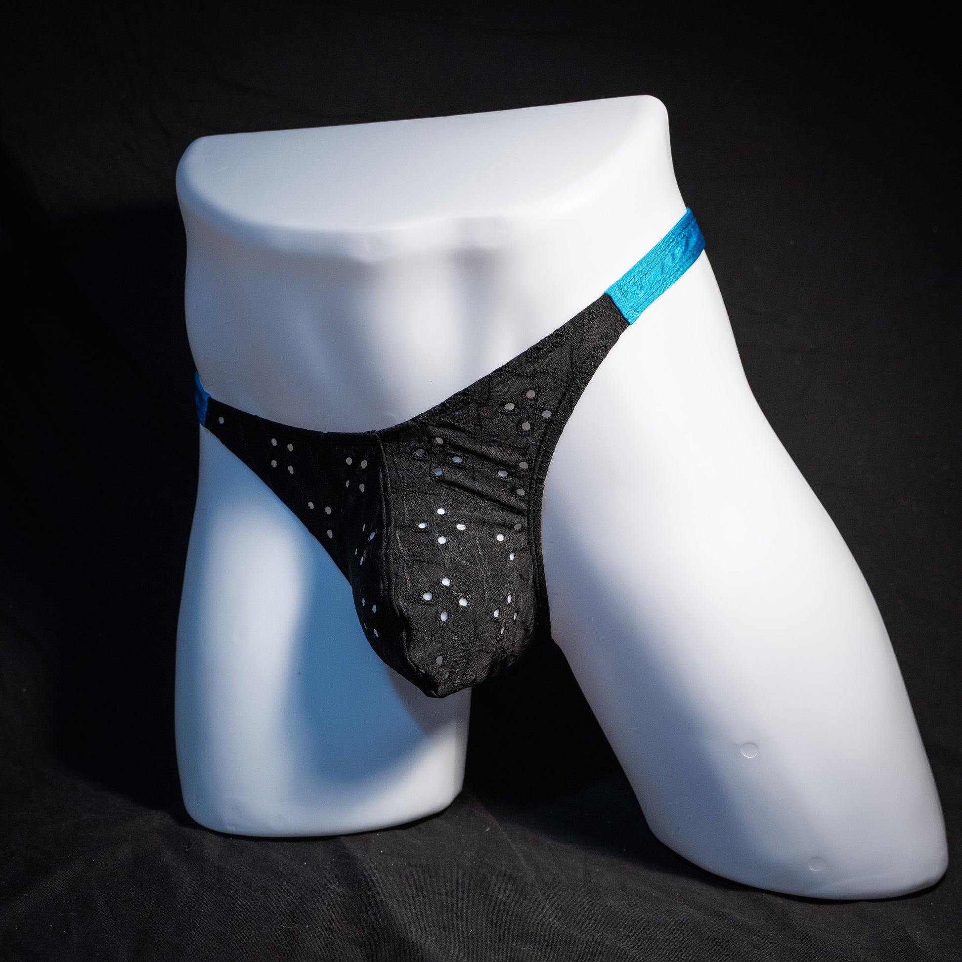 Men's black and blue eyelet thong underwear, classic cut, front view.