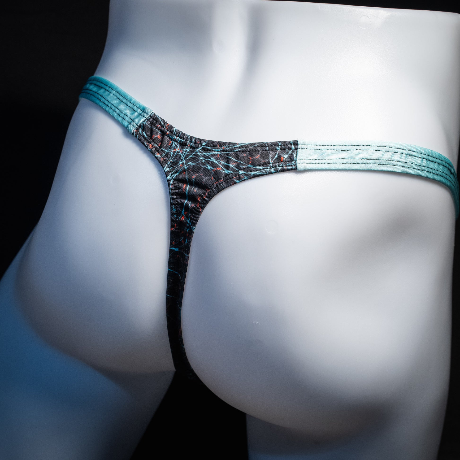 Men's black and blue thong underwear, classic cut, rear view.