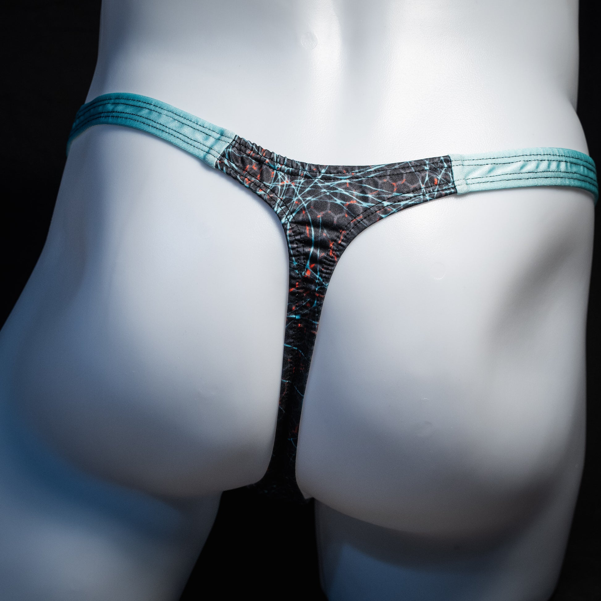 Men's black and blue thong underwear, classic cut, rear view.