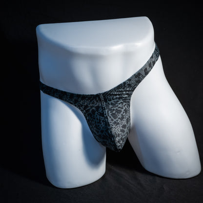 Men's black and grey abstract print thong underwear, slim cut, front view.