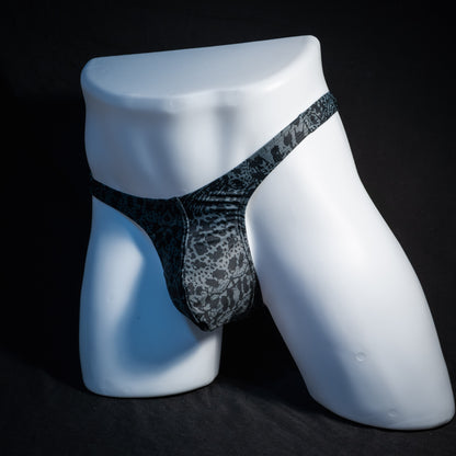 Men's black and grey abstract print thong underwear, slim cut, front view.