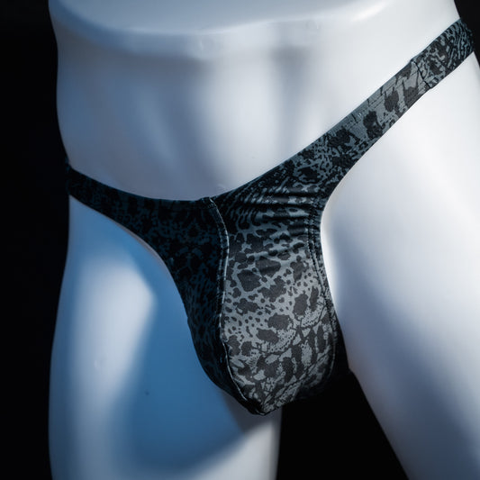Men's black and grey abstract print thong underwear, slim cut, front view.