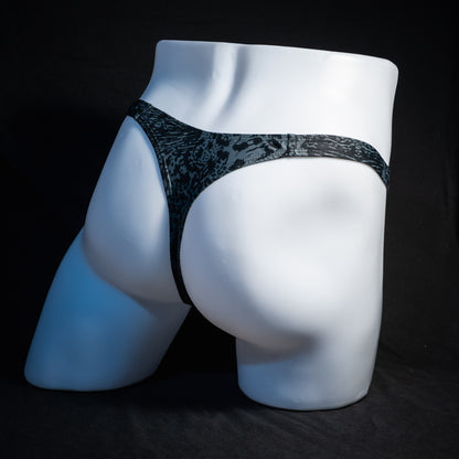 Men's black and grey abstract print thong underwear, slim cut, rear view.
