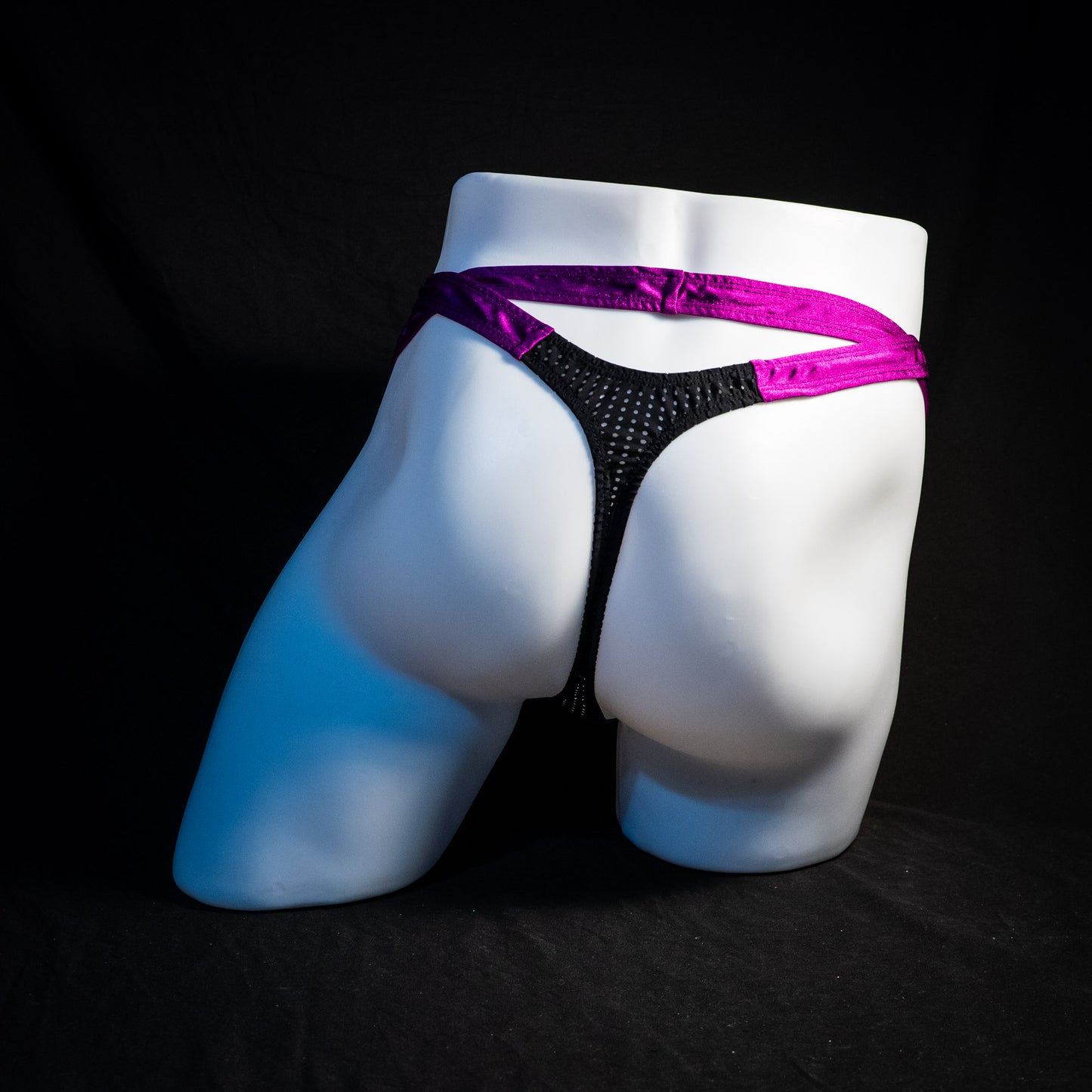 Men's double strap black mesh with purple straps, thong underwear, tower cut, full rear view.