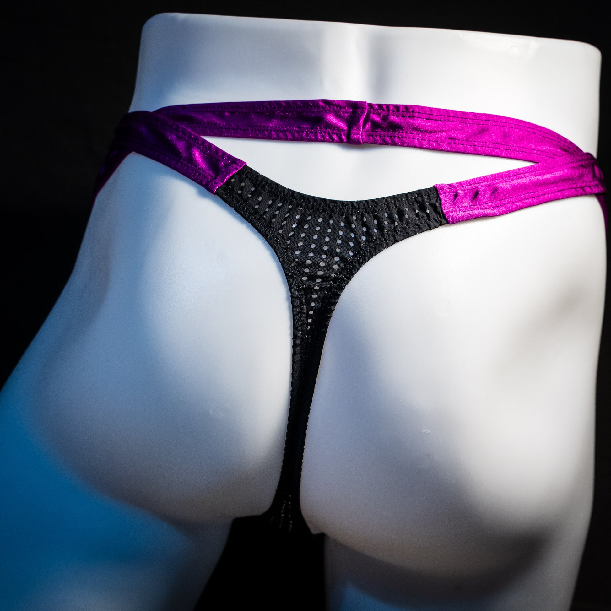 Men's double strap black mesh with purple straps, thong underwear, tower cut, rear view.