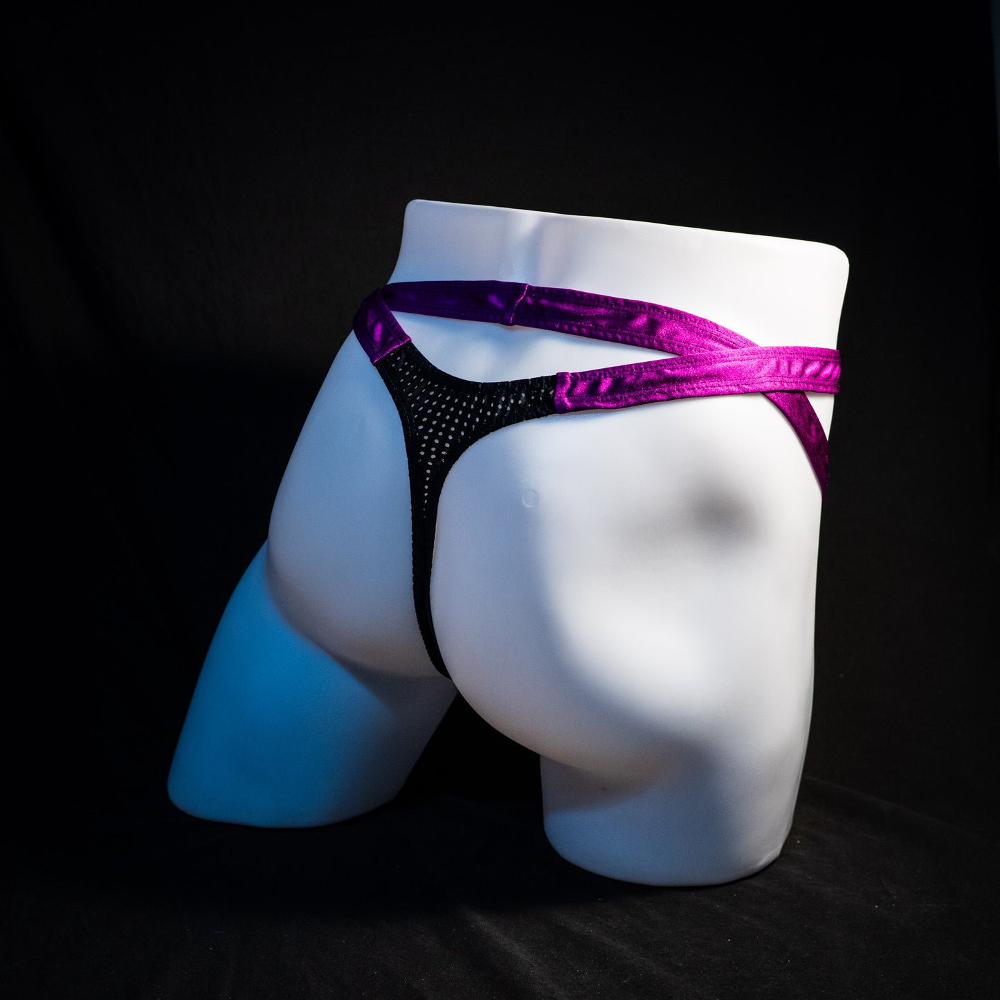 Men's double strap black mesh with purple straps, thong underwear, tower cut, full angled rear view.