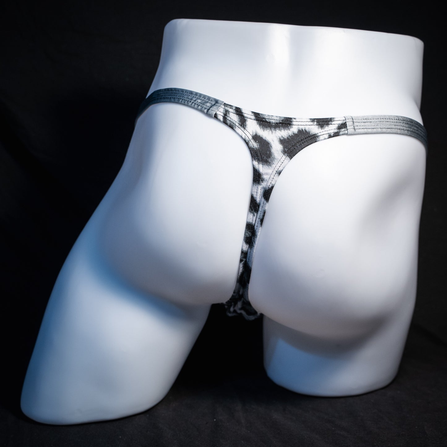 Men's black and white leopard thong underwear, classic cut, rear view.