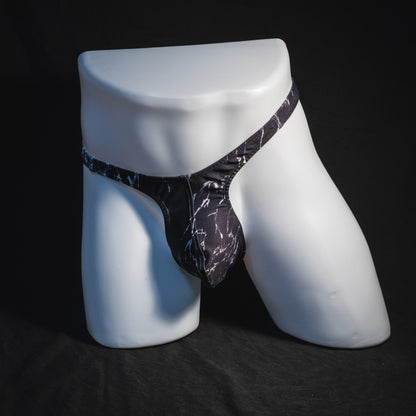 Men's black and white marble thong underwear, tower cut, full front view.