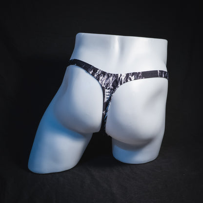 Men's black and white marble thong underwear, tower cut, full rear view.