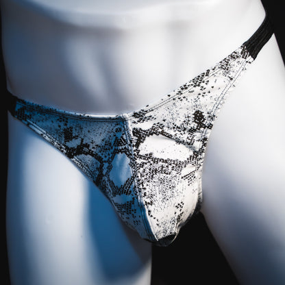 Men's black and white snakeskin thong underwear, classic cut, angled front view.