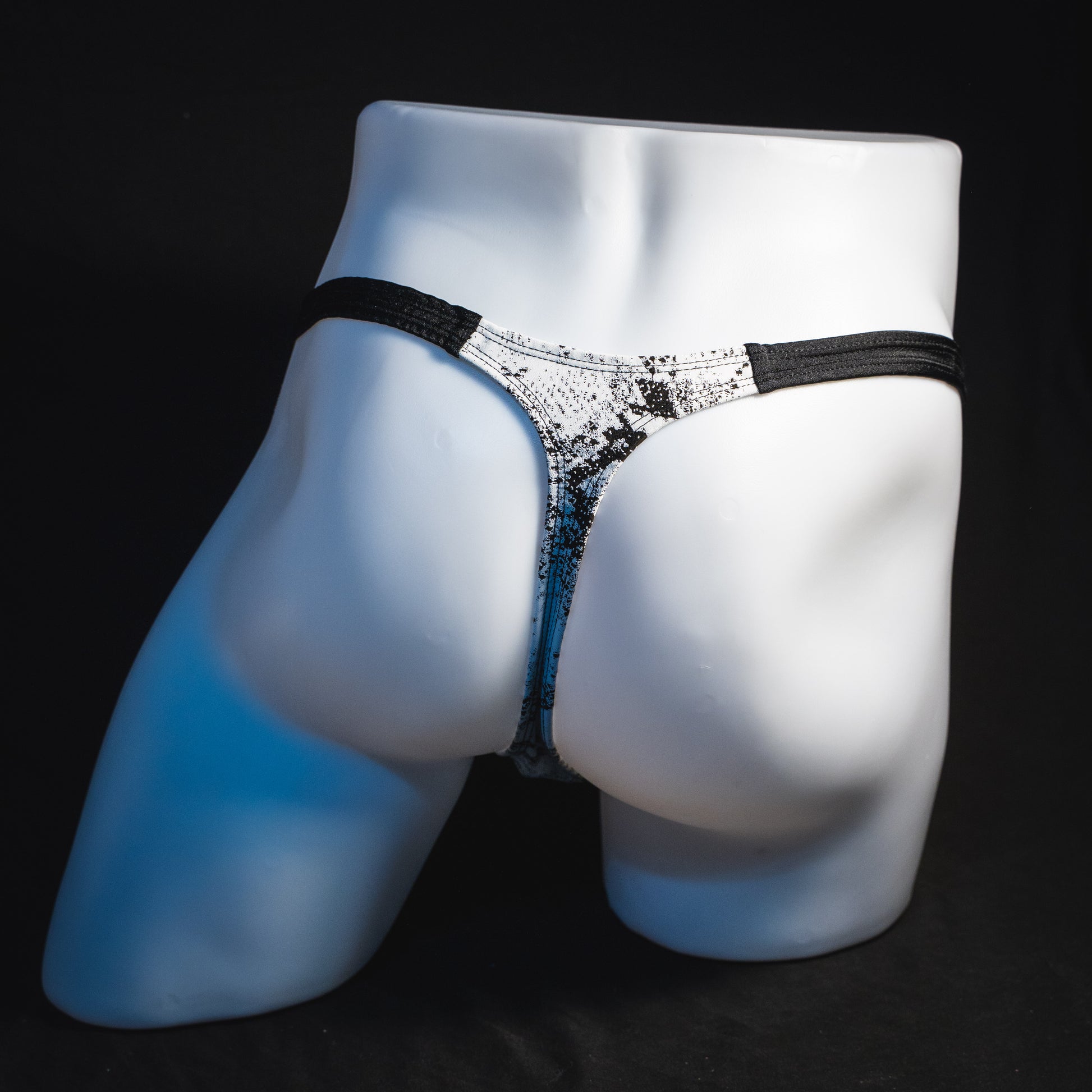 Men's black and white snakeskin thong underwear, classic cut, full rear view.