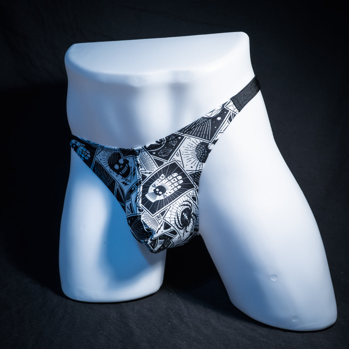 Men's black and white tarot thong underwear, classic cut, front view.