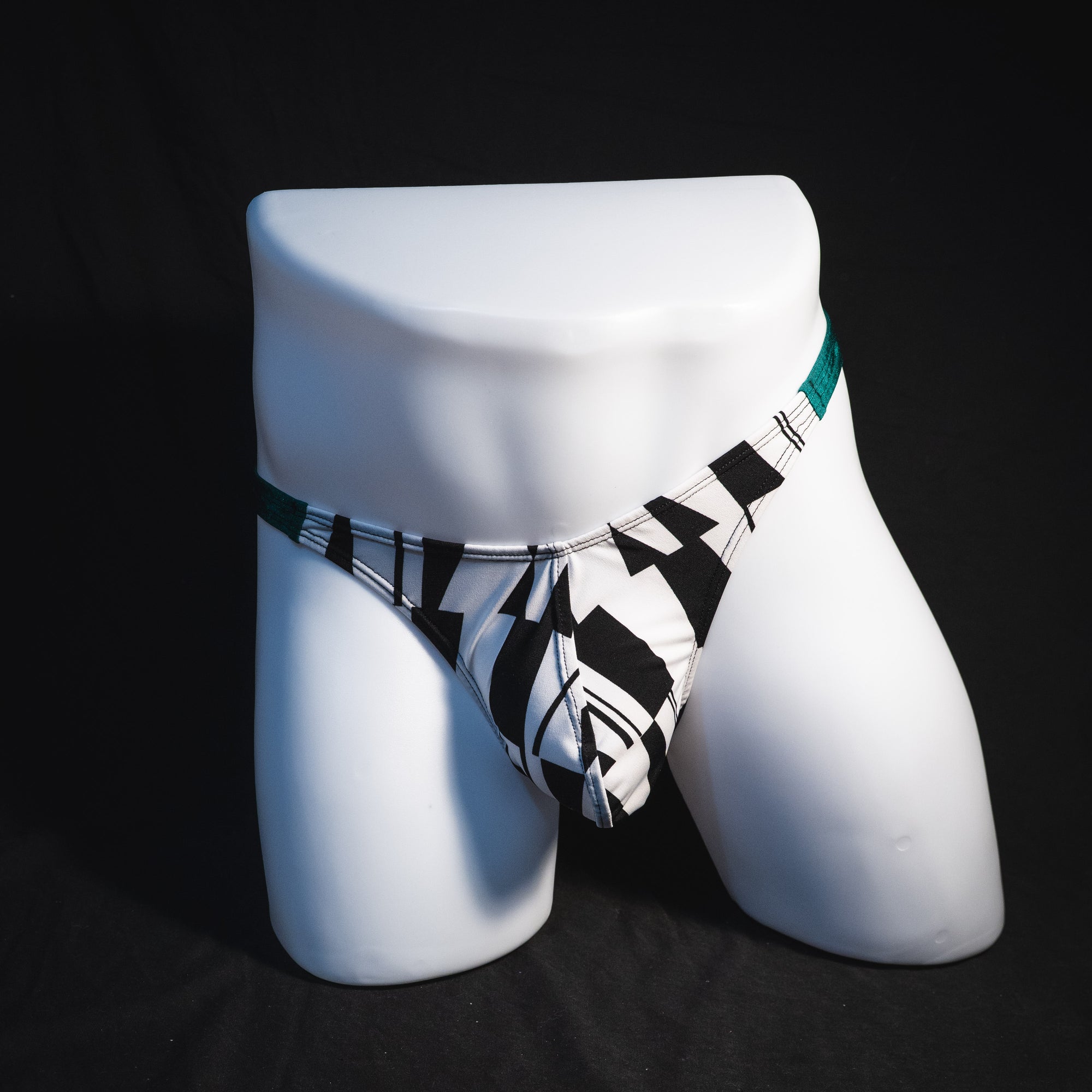 Men's black and white geometric thong underwear with green side straps, classic cut, Full front view