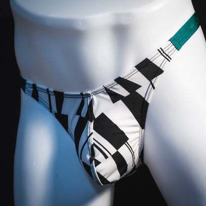 Men's black and white geometric thong underwear with green side straps, classic cut, Front angled view