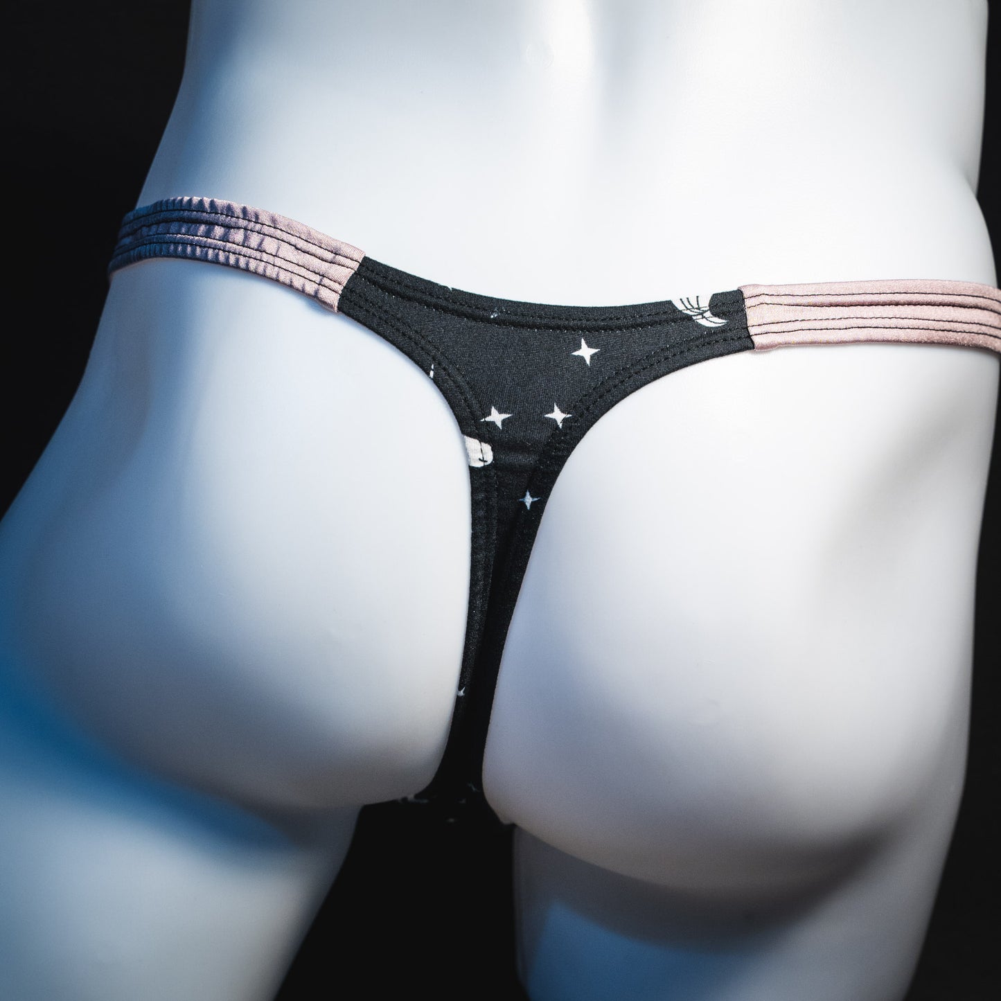 Men's black and white unicorn thong underwear, classic cut, rear view.