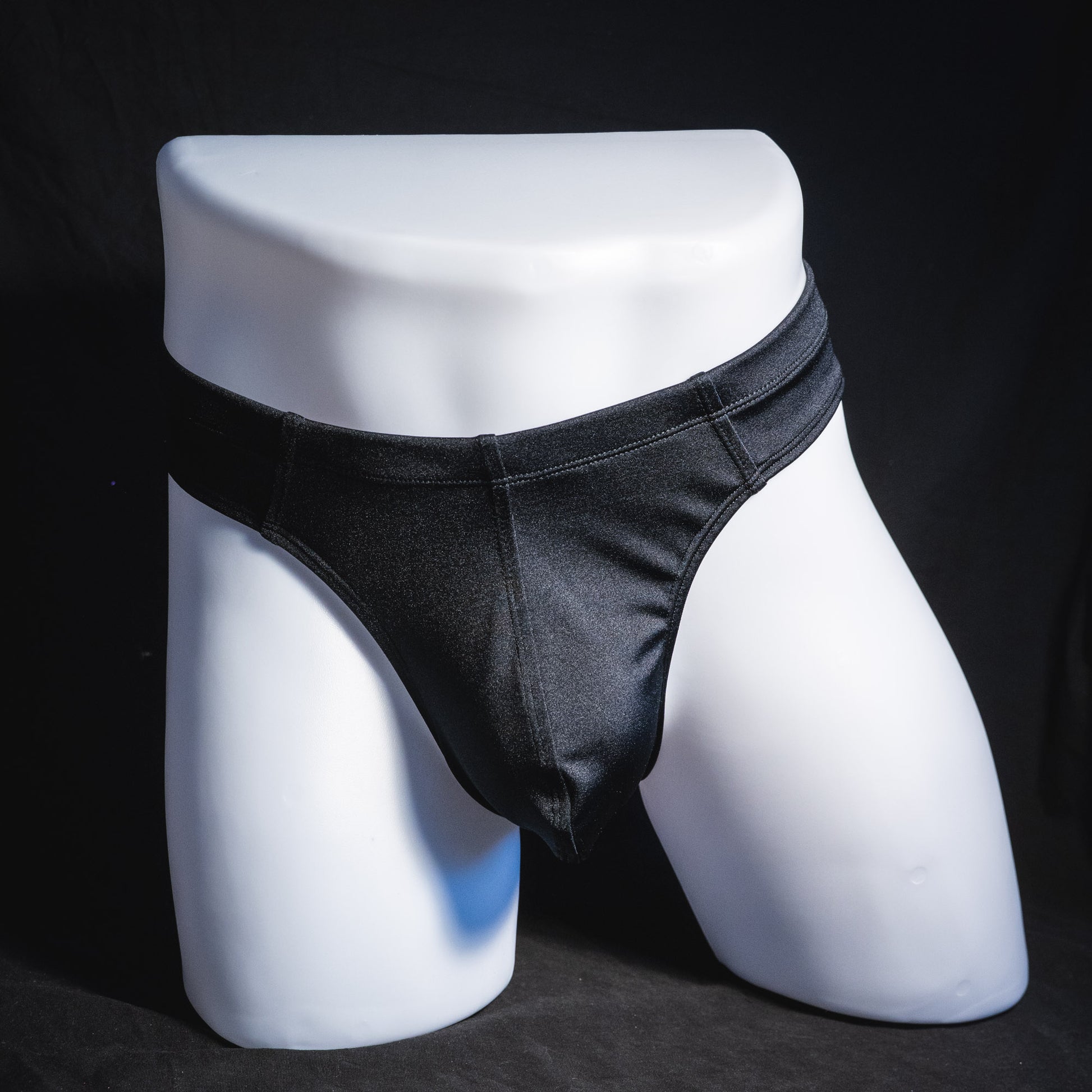 Men's black brief cut thong underwear, full front view.