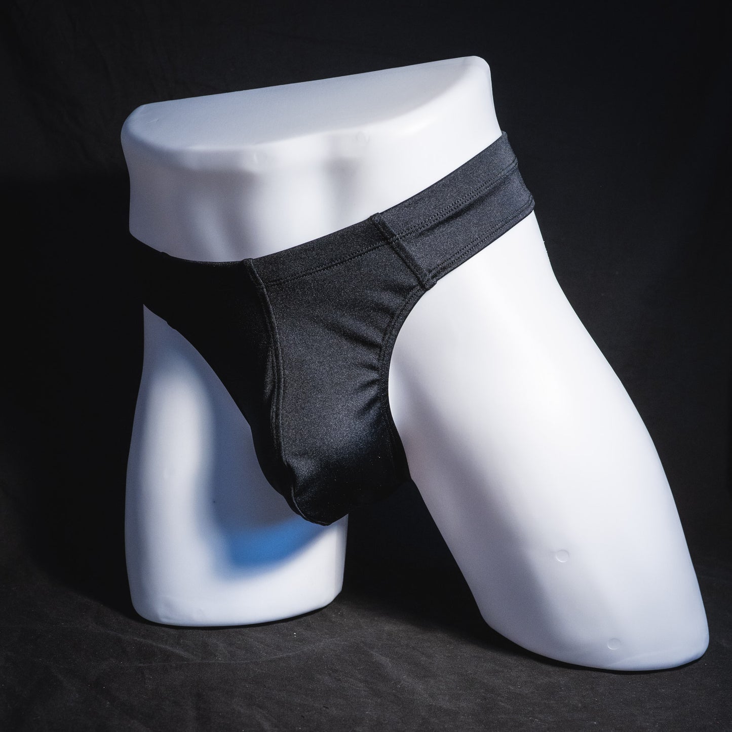 Men's black brief cut thong underwear, full angled front view.