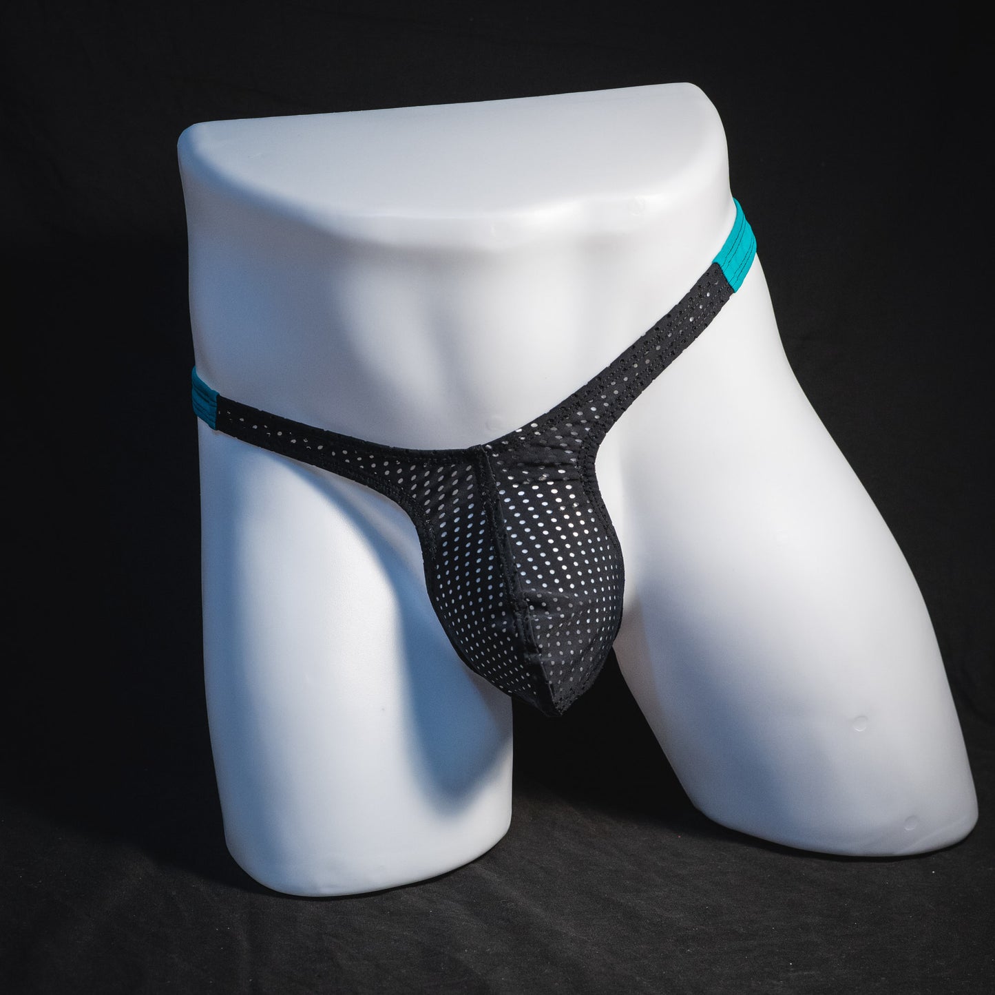 Black mesh with teal waistband, men's thong underwear, tower cut, full front view.