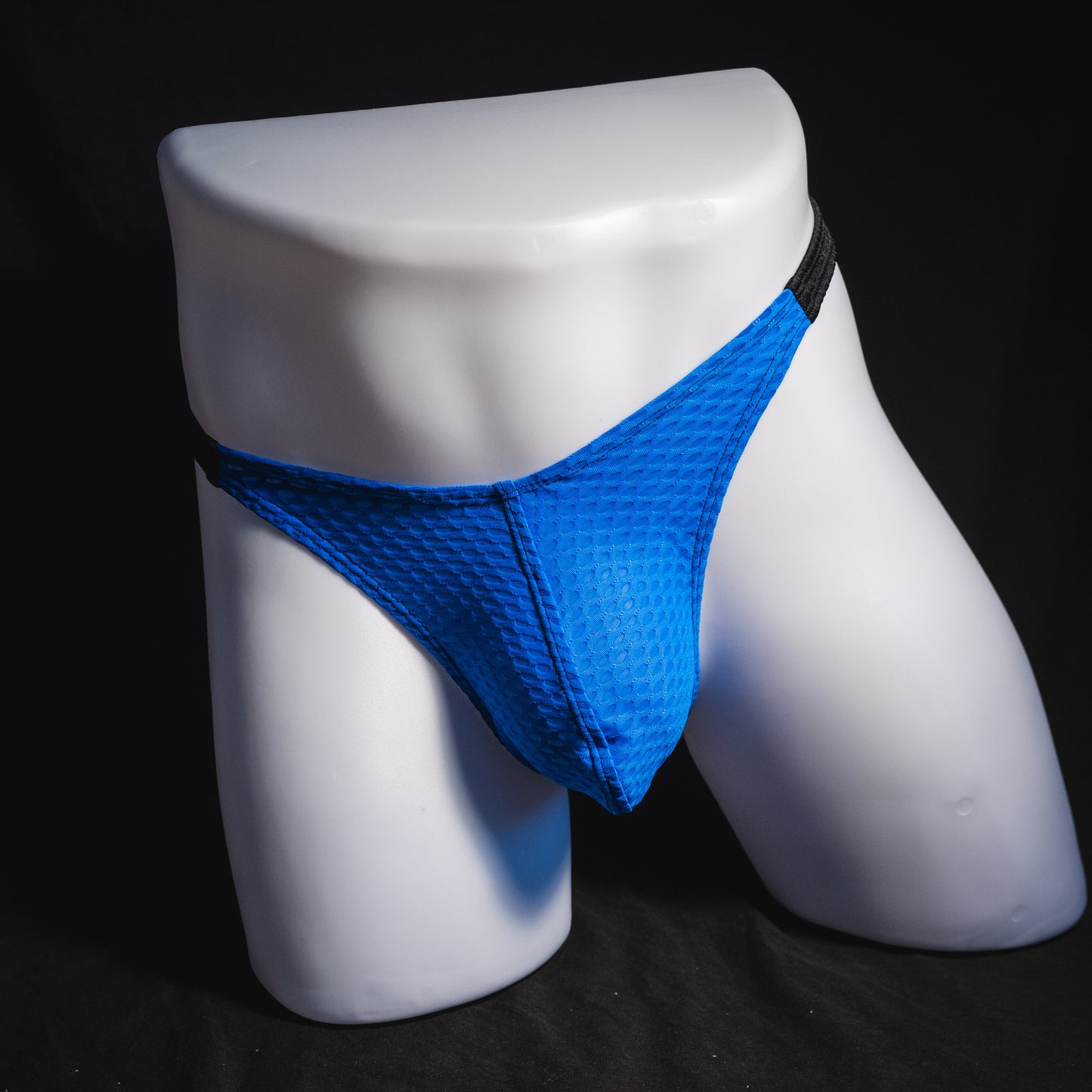 Men's blue and black athletic mesh thong underwear, classic cut, full front view.