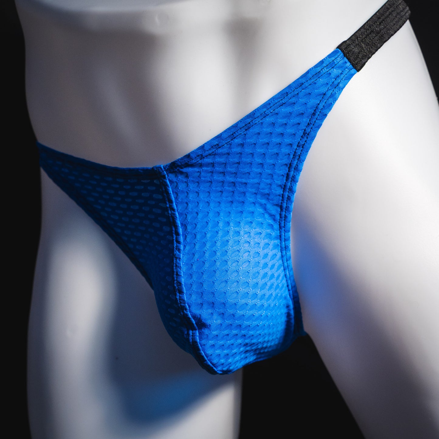Men's blue and black athletic mesh thong underwear, classic cut, angled front view.
