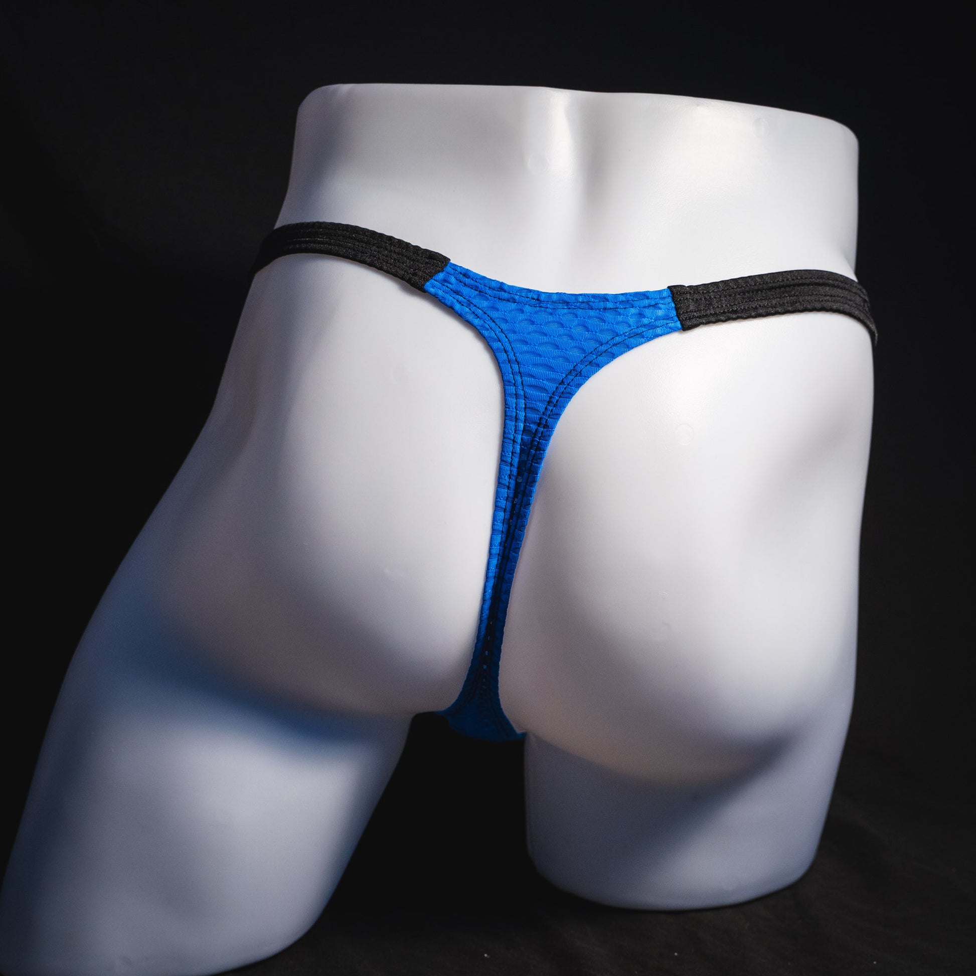 Men's blue and black athletic mesh thong underwear, classic cut, full rear view.
