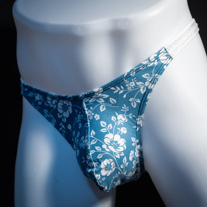 Men's blue and white floral thong underwear, classic cut, front view.