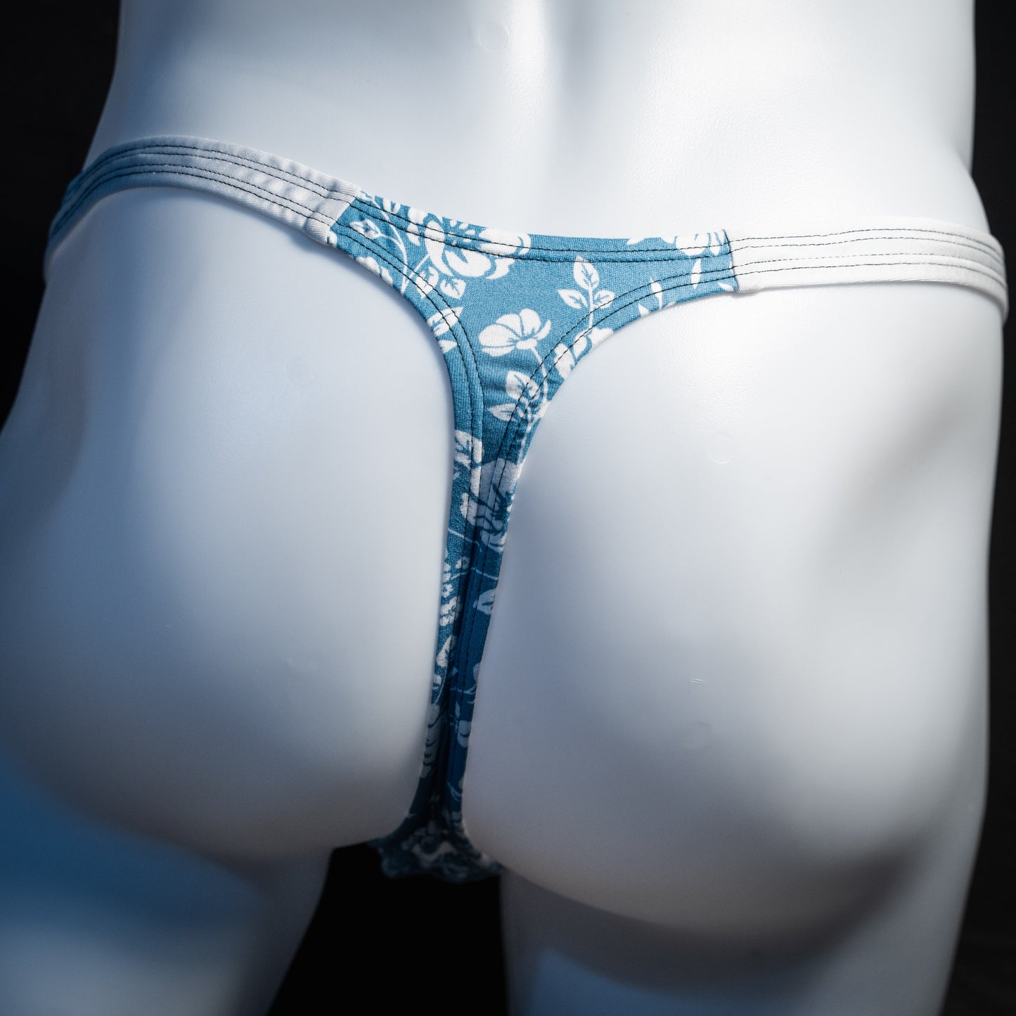 Men's blue and white floral thong underwear, classic cut, rear  view.