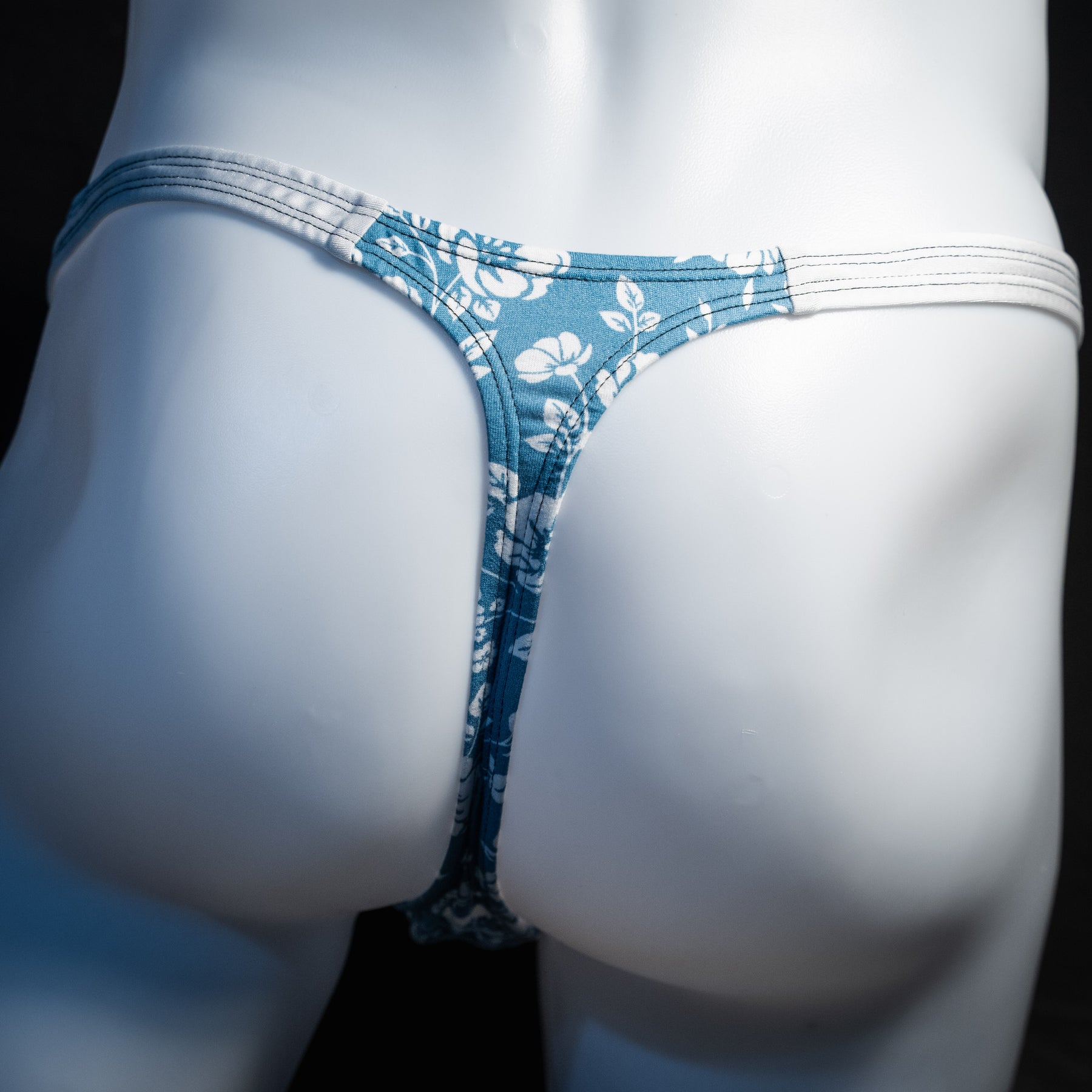 Men's blue and white floral thong underwear, classic cut, rear  view.