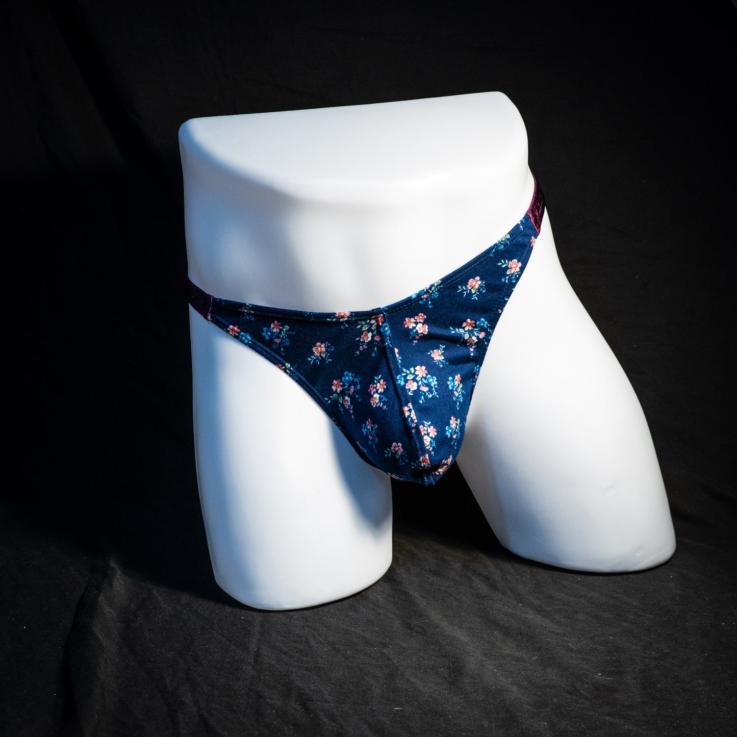 Men's blue floral thong underwear, classic cut, full front view.