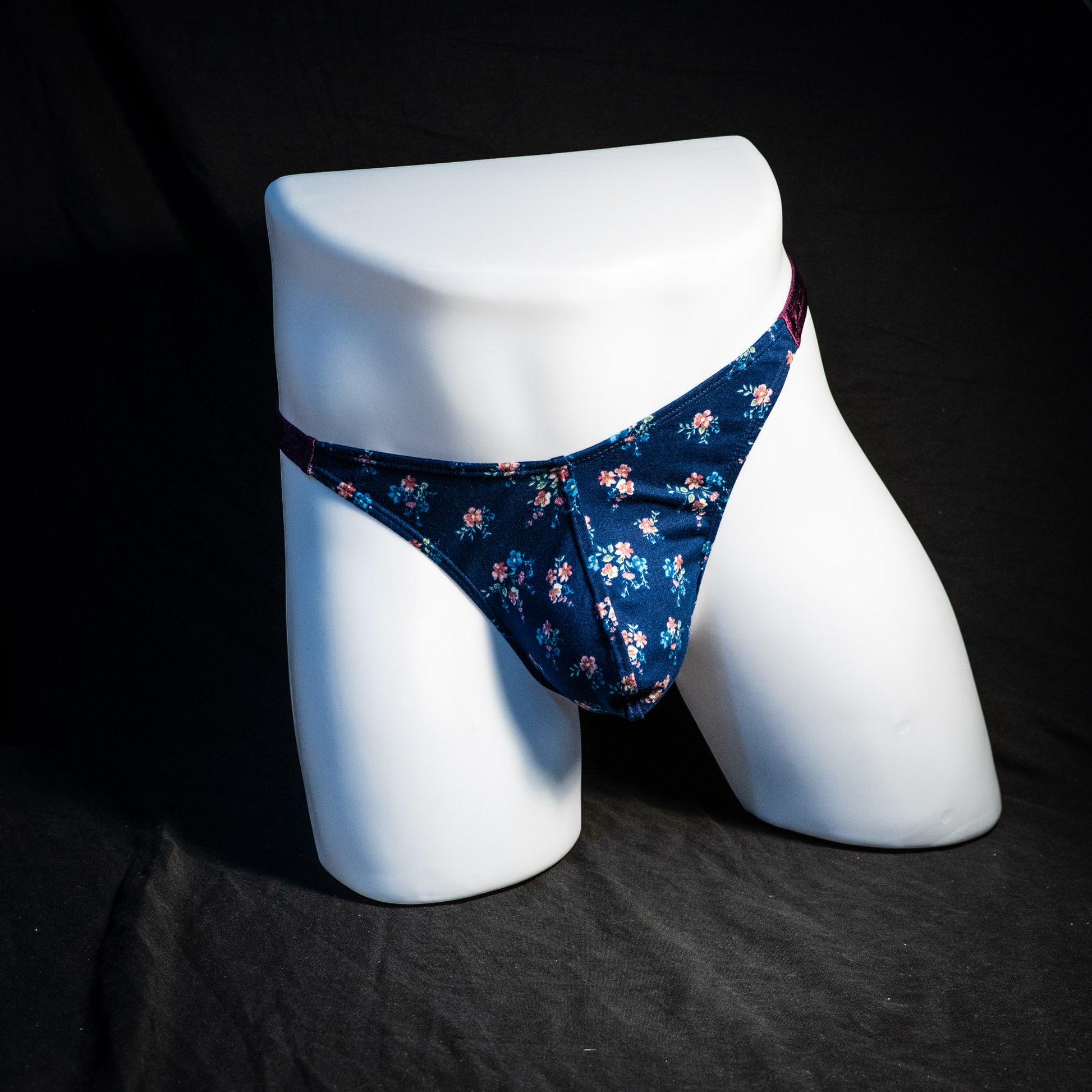 Men's blue floral thong underwear, classic cut, full front view.