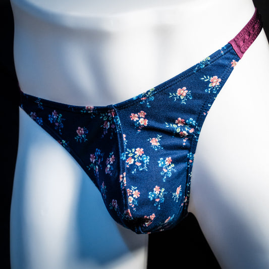 Men's blue floral thong underwear, classic cut, front angled view.