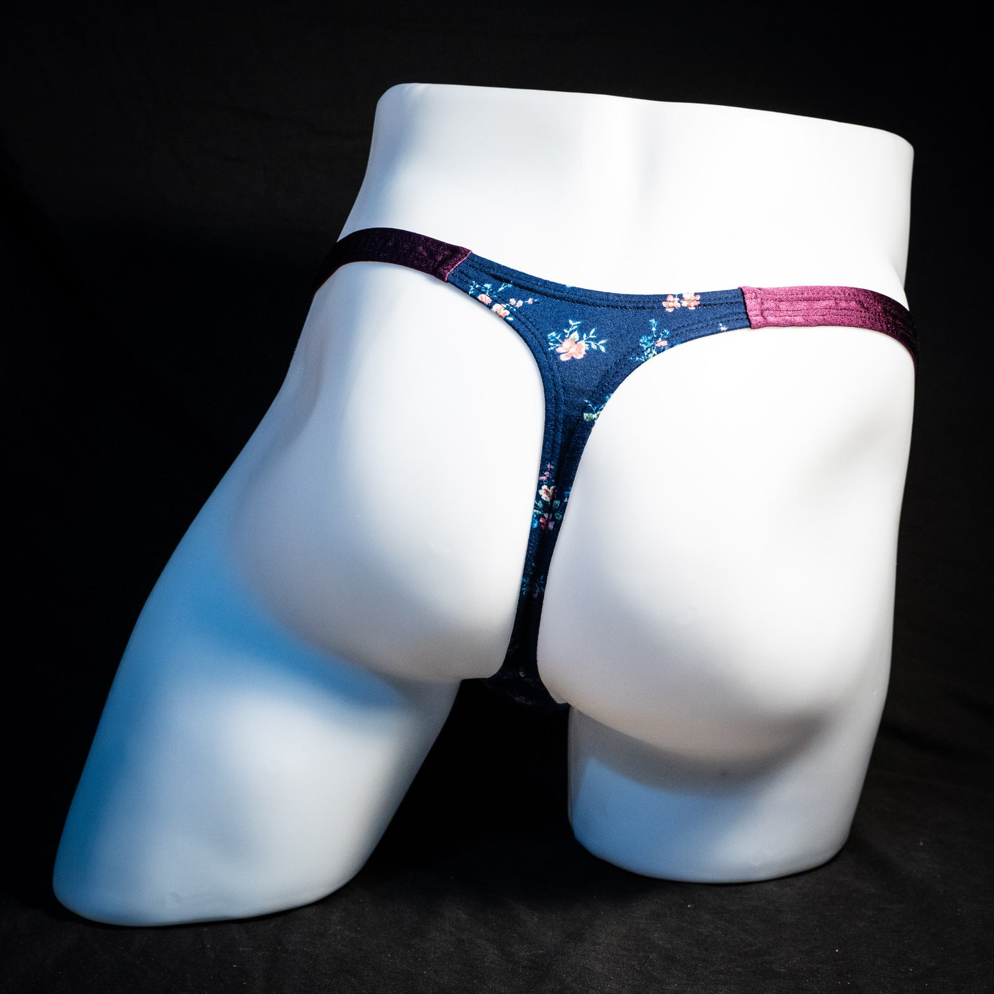 Men's blue floral thong underwear, classic cut, full rear view.