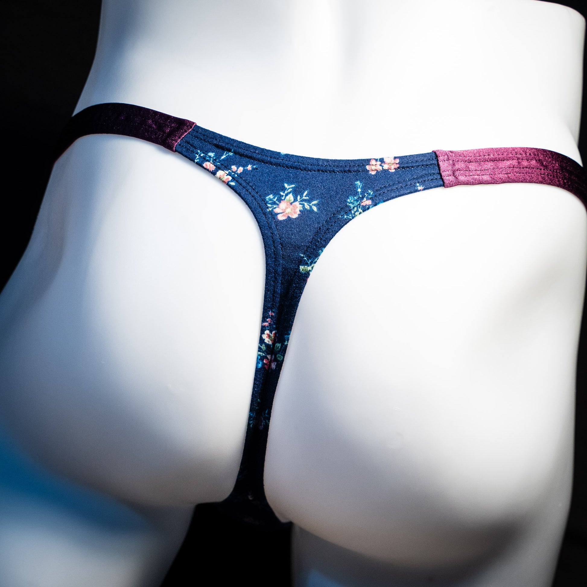 Men's blue floral thong underwear, classic cut, rear view.