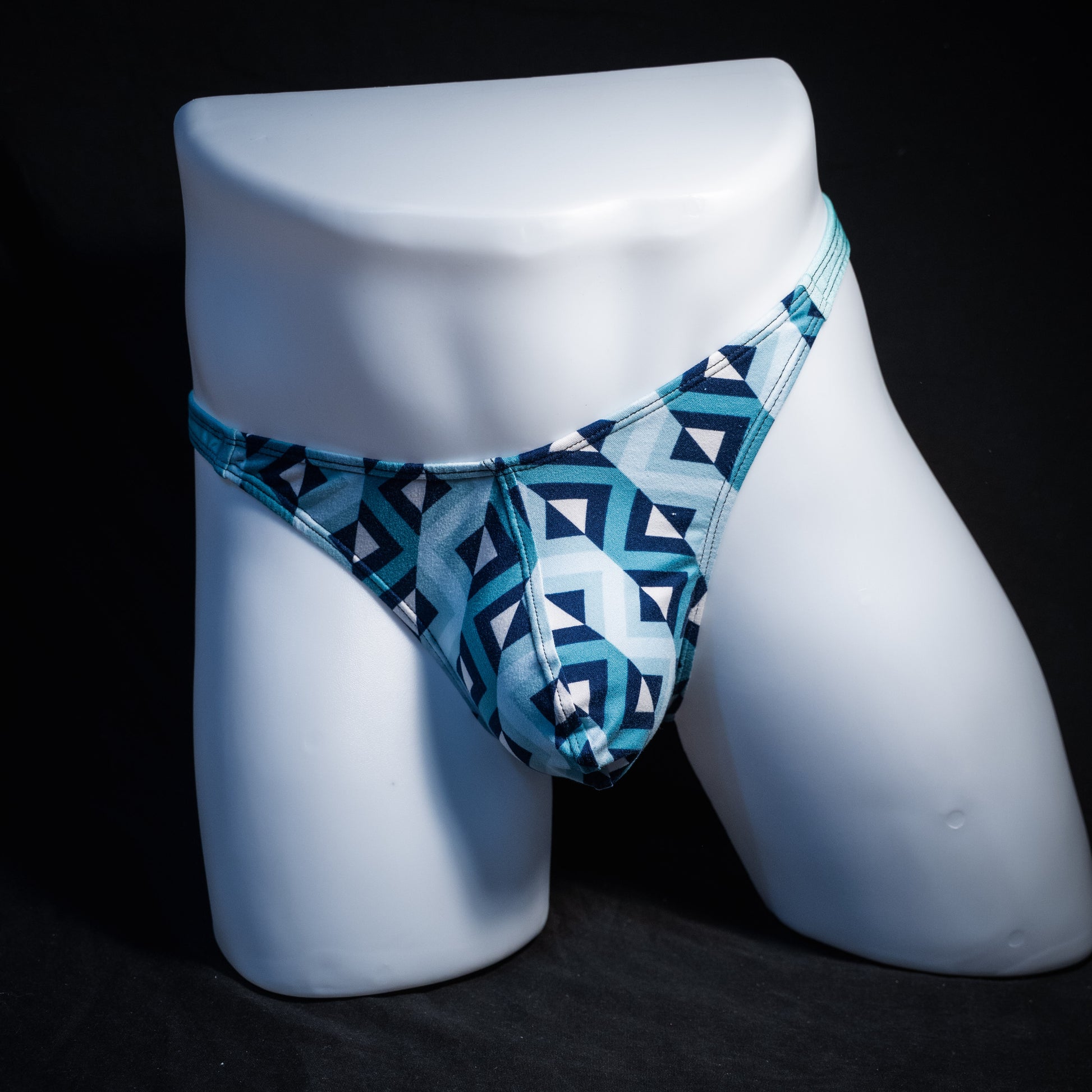 Men's blue geometric thong underwear, classic cut, front view.