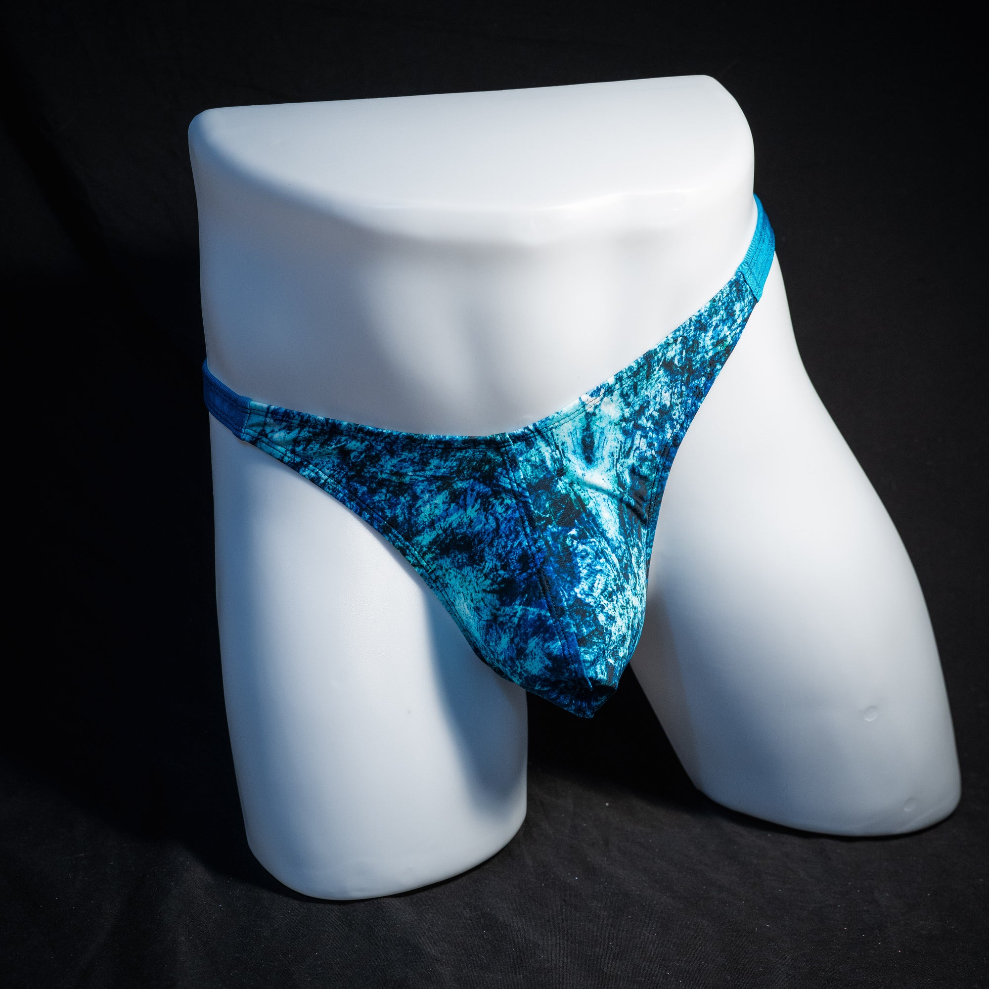 Men's blue ocean thong underwear, classic cut, front view.