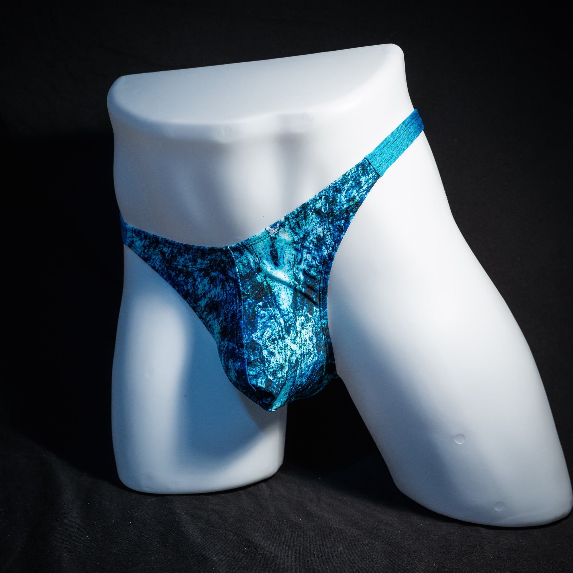 Men's blue ocean thong underwear, classic cut, front view.
