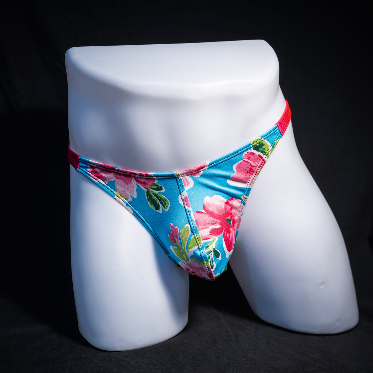 Men's blue with pink flowers thong underwear, classic cut, front view.