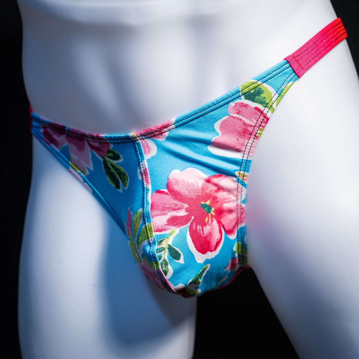 Men's blue with pink flowers thong underwear, classic cut, front view.