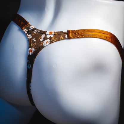 Men's brown earth tone floral thong underwear, classic cut, angled rear view.