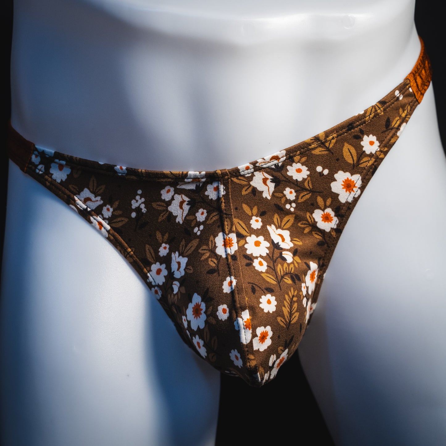 Men's brown earth tone floral thong underwear, classic cut, front view.