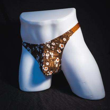 Men's brown earth tone floral thong underwear, classic cut, full angled front view.